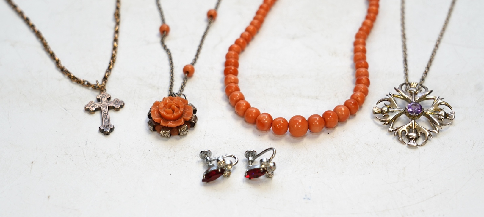 A Victorian yellow metal crucifix on a yellow metal chain, a coral necklace and other assorted jewellery. Condition - fair to poor